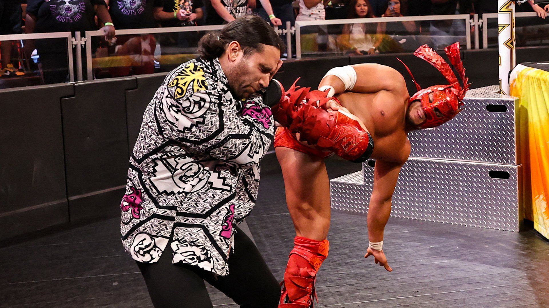 Dragon Lee kicking Noam Dar